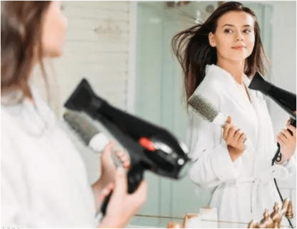 Satisfied customer holding Solia Hair Dryer, emphasizing its user-friendly design